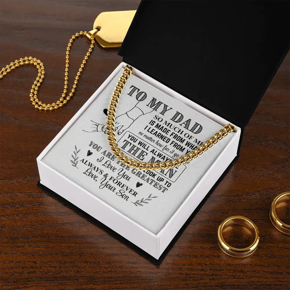 Gold chain necklace in a black and white gift box with a father-son message on a wooden surface
