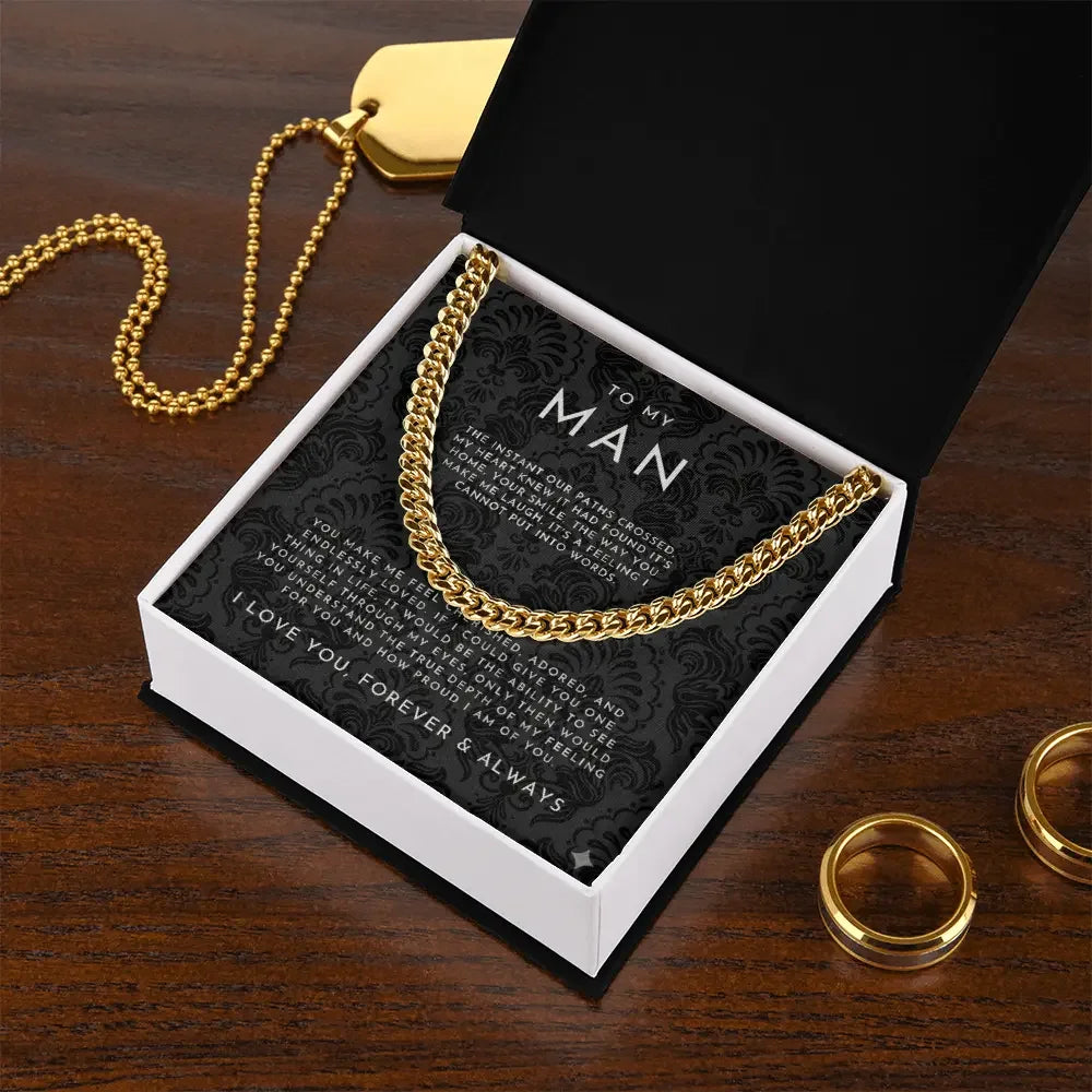 Gold chain necklace in gift box with romantic message to my man, on wooden table with gold rings and dog tag