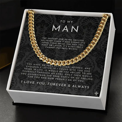 Gold chain necklace in white box with black patterned card reading romantic message to my man