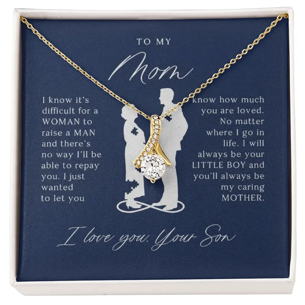 Gold necklace with a sparkling pendant in a gift box featuring a sentimental message from a son to his mom