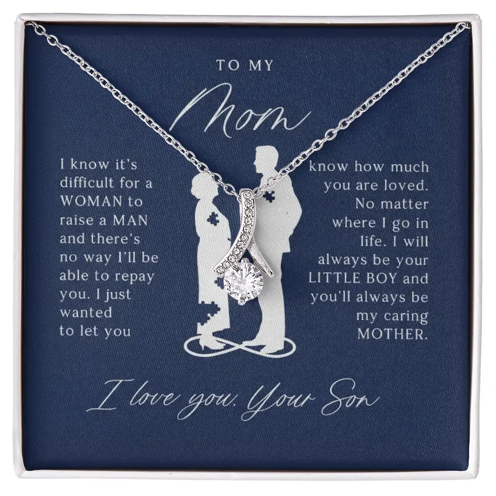 Silver necklace with a sparkling pendant on a navy card with a son's heartfelt message to mom