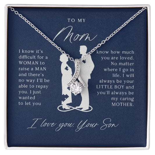 Silver necklace with a sparkling pendant on a navy card with a son's heartfelt message to mom