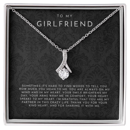 Silver necklace with a sparkling heart pendant in a gift box saying To My Girlfriend with a loving message