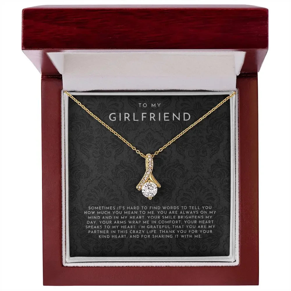 Gold pendant necklace with crystal in a red gift box, message card for girlfriend, elegant jewelry gift