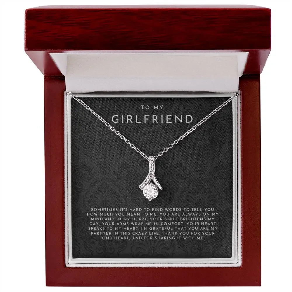 Silver necklace with sparkling pendant in red gift box, message 'To my girlfriend' with heartfelt note