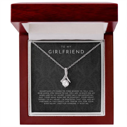 Silver necklace with sparkling pendant in red gift box, message 'To my girlfriend' with heartfelt note