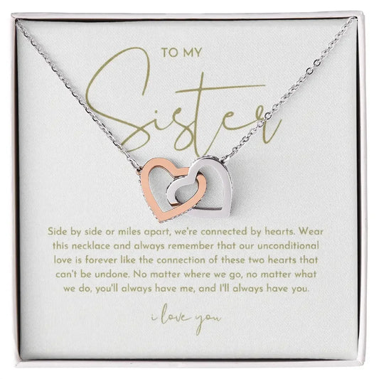 Alanes sister necklace with interlocking rose gold and silver hearts on chain in gift box with message